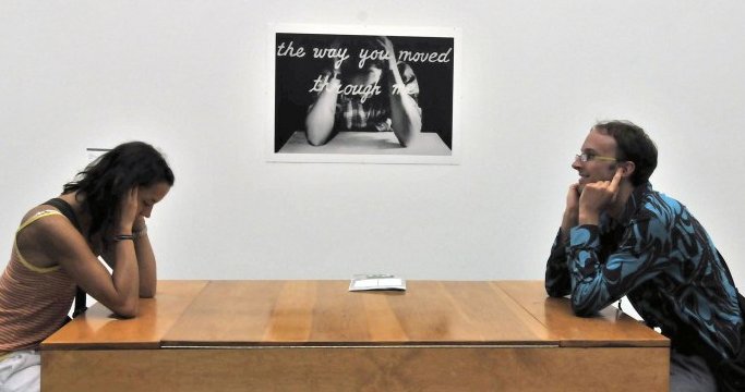 Poster for See this Sound: Woman sitting at handphone table